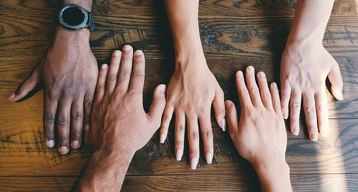 5 hands in a line together symbolizing the value of community support