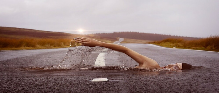 someone using the skills they have learned to swim effortlessly across a large river.