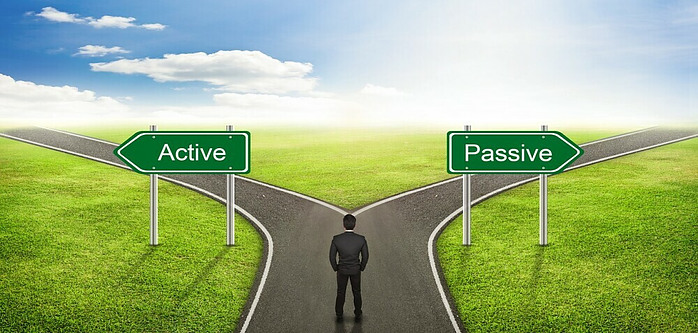 a man standing at a fork in the raod, one leading to a passive income and one leading to an active on.