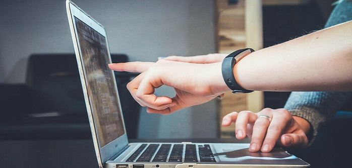 a person pointing to a computer screen with valuable content