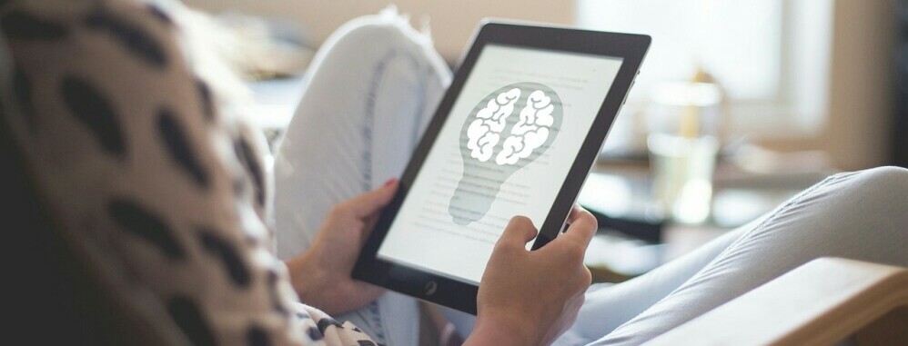 a tablet showing a brain inside a lightbulb to emphasize the importance of mindsest