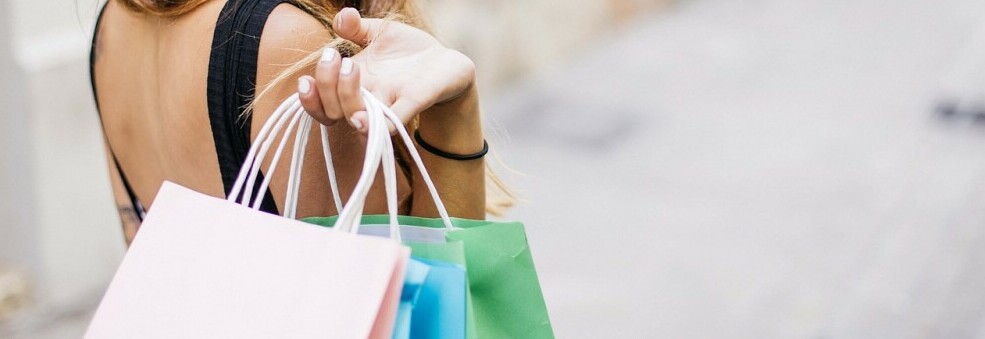 a woman holding shopping bags from precent purchases