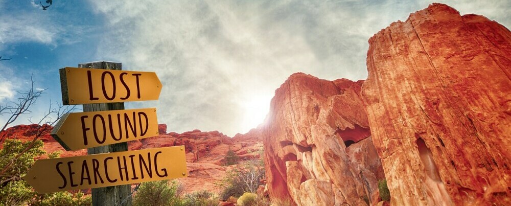 a picturesque mountain view with directional signs saying 