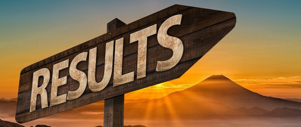 a sign pointing to results
