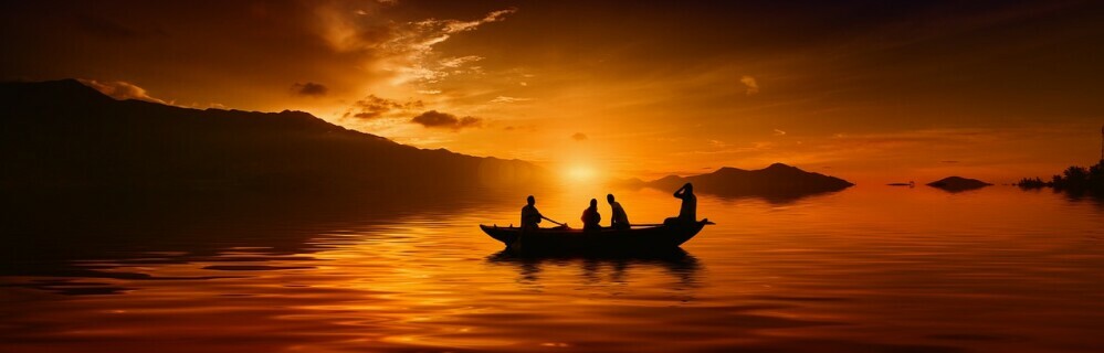 a full canoe on the lake at sunset showing the power of mindset