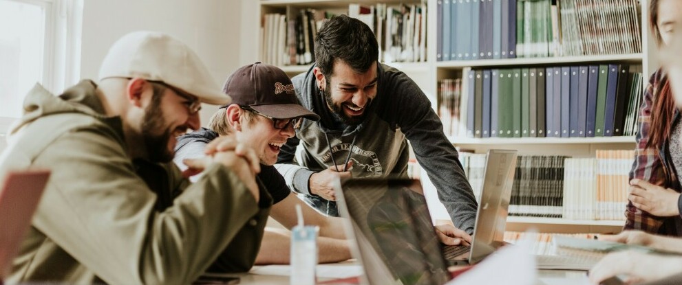 a group of entrepreneurs laughing while working together