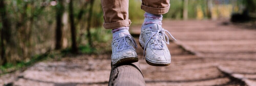 a man doing a balance beam walk to show the importance of balance