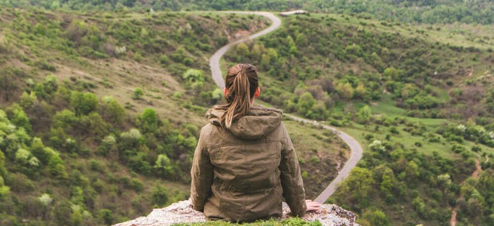 a woman about to begin her journey along the road less travelled