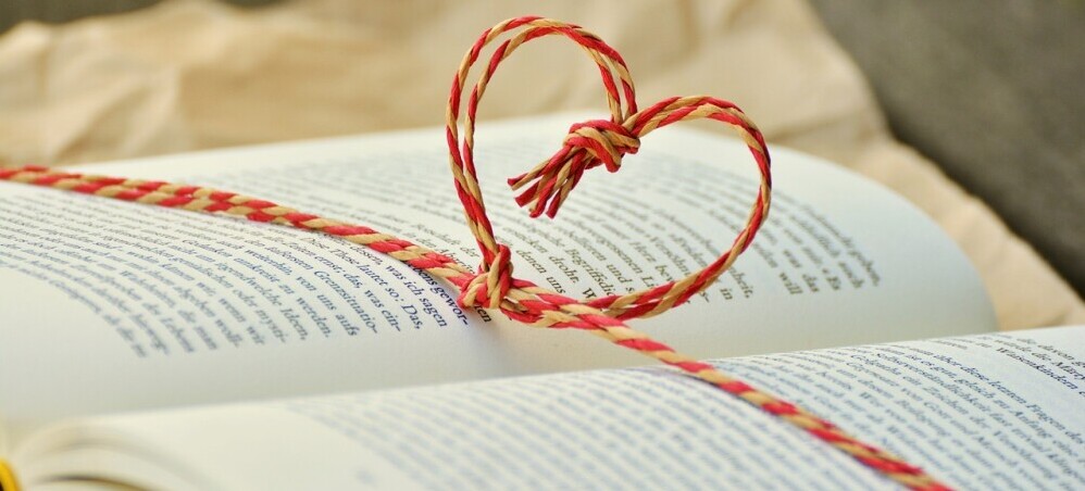 a book wrapped with a heart as an educational gift